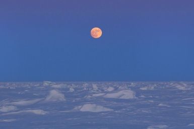 The moon rises over Arctic ice