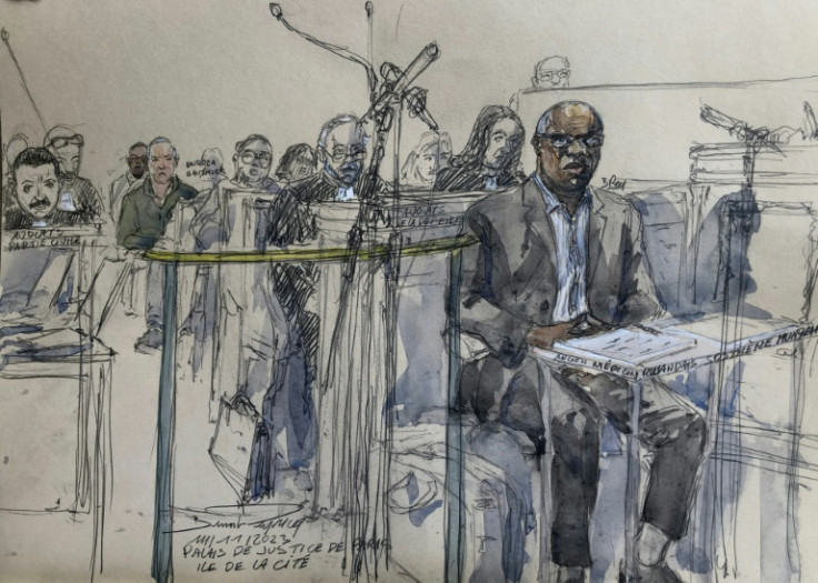 The court sketch made on November 14, 2023 shows Rwandan former doctor Sosthene Munyemana (R) attending his genocide trial at the Palais de Justice courthouse in central Paris