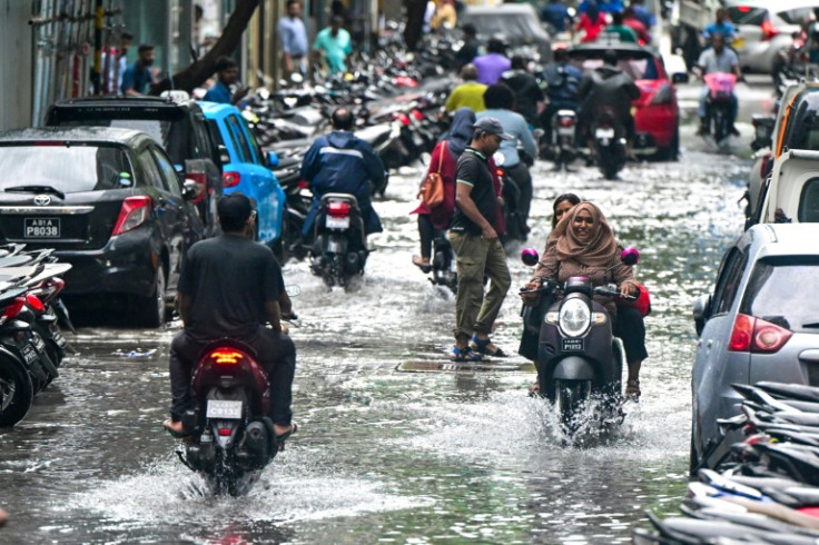 Motorists drive along a street after a heavy downpour in Male, the capital of the Maldives