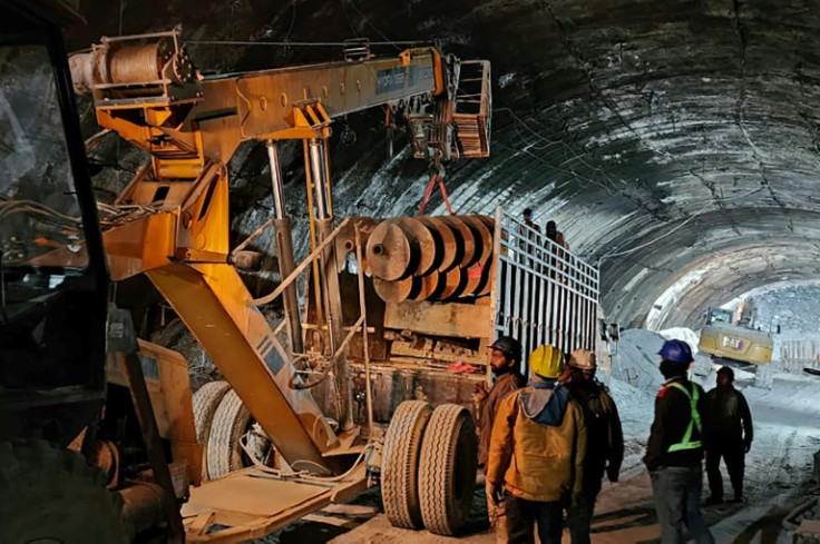 Heavy machines have been brought in to bore a new tunnel through the debris to rescue the 40 workers