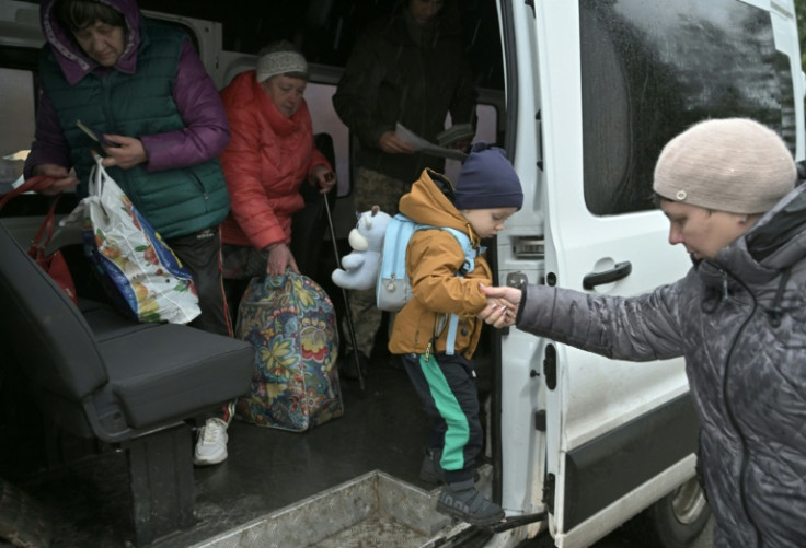 Ukrainians who arrived through the humanitarian corridor from Russia's Belgorod region exit the bus at a centre on Ukraine's eastern border
