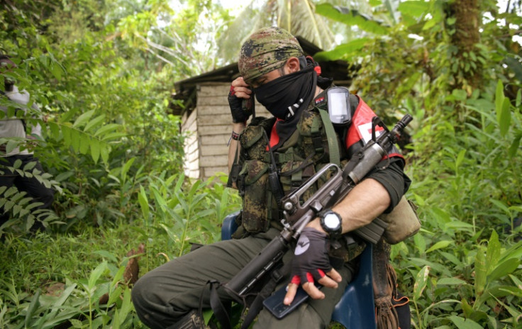 A member of Colombia's National Liberation Army (ELN) rebel group is seen near the Baudo river -- AFP was invited to interview a rebel commander in an ELN stronghold
