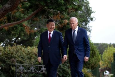 US President Joe Biden (R) and Chinese President Xi Jinping walk together after a meeting during the Asia-Pacific Economic Cooperation (APEC) Leaders' week