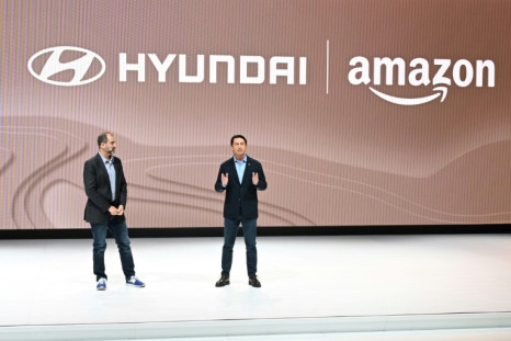 Amazon Vice President Marty Mallick (L) and Hyundai Global President Jose Munoz speak at the media preview day for the Los Angeles Auto Show, on November 16, 2023