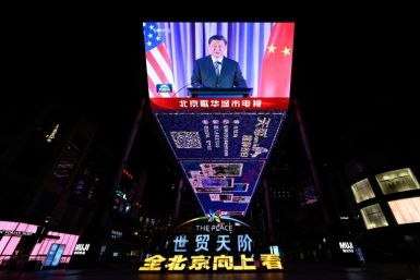 An outdoor screen in Beijing shows a news program about Chinese President Xi Jinping speaking on the sidelines of the Asia-Pacific Economic Cooperation (APEC) summit in San Francisco