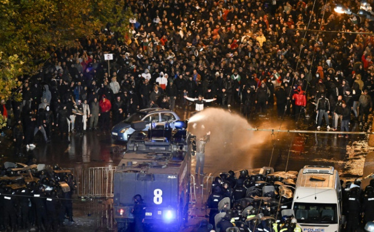 Police use a water cannon against protesters outside the Vassil Levski Stadium in Sofia where Bulgarian fans were protesting against the head of their football federation