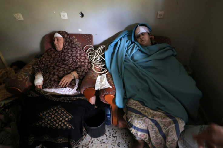 Members of the Palestinian Rifi family recover from a bombing that claimed seven relatives