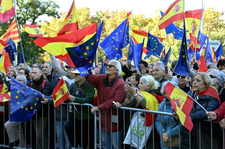 Demonstrators wave flags as they take part in a protest against an amnesty bill for people involved with Catalonia's failed 2017 independence bid