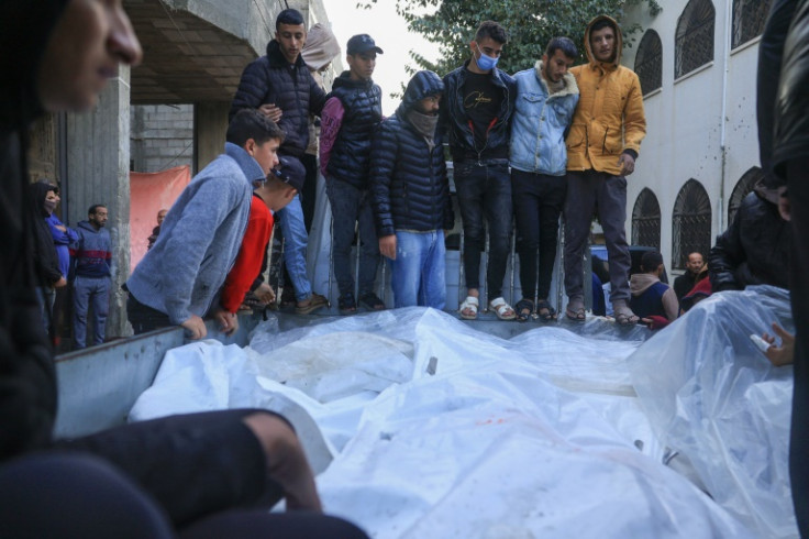 Palestinians transport the shrouded bodies of relatives killed following an Israeli strike in Rafah in the southern Gaza Strip