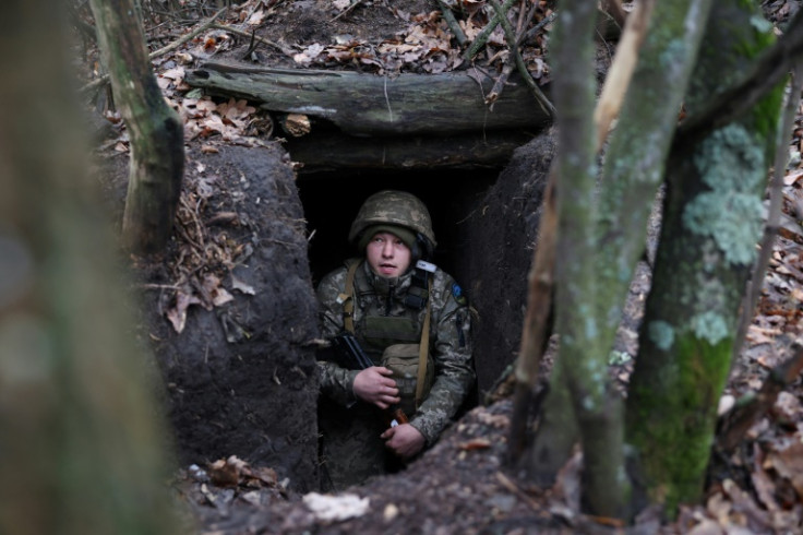 A Ukrainian serviceman looks out from an underground shelter on the frontline near the town of Bakhmut