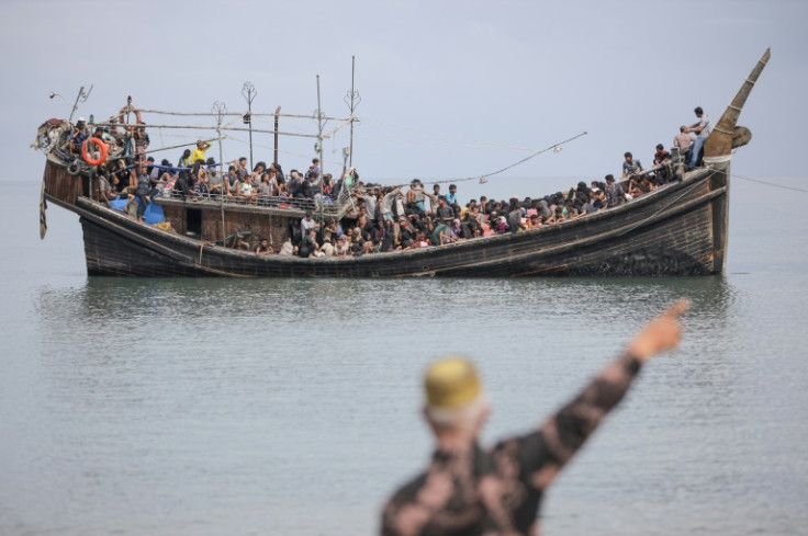 Hundreds of Rohingya refugees in an overcrowded wooden boat have been turned away from western Indonesia and forced back to sea
