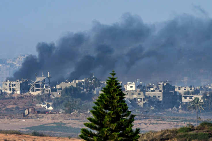 Seen from southern Israel, smoke rises from buildings still smouldering after being hit by Israeli strikes before the four-day truce began