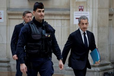 France's former president Nicolas Sarkozy (R) arrives at the Paris court for questioning during the appeal trial in the so-called Bygmalion case