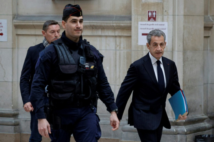 France's former president Nicolas Sarkozy (R) arrives at the Paris court for questioning during the appeal trial in the so-called Bygmalion case