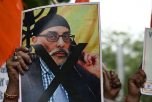 A member of United Hindu Front organisation, at a New Delhi rally, holds a banner depicting Gurpatwant Singh Pannun, a lawyer and US citizen reportedly targeted for assassination by an Indian government official