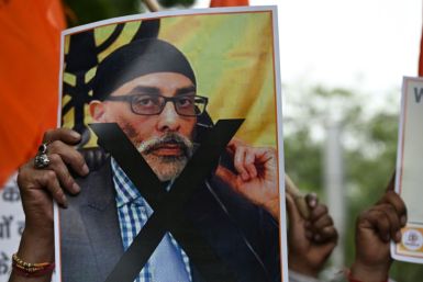 A member of United Hindu Front organisation, at a New Delhi rally, holds a banner depicting Gurpatwant Singh Pannun, a lawyer and US citizen reportedly targeted for assassination by an Indian government official