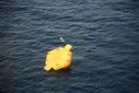 A photo released by Japan's coastguard shows what appears to be an overturned life raft during rescue operations after a US Osprey aircraft crashed into the sea