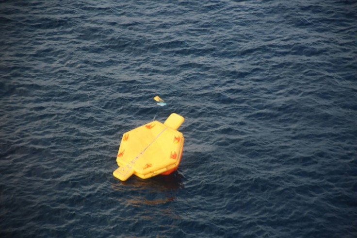 A photo released by Japan's coastguard shows what appears to be an overturned life raft during rescue operations after a US Osprey aircraft crashed into the sea