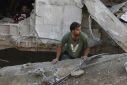 A man searches for survivors in a bombed-out building in Rafah on December 1
