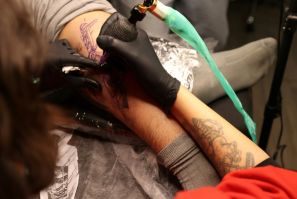 A tattoo artist traces a design on a customer at a tattoo studio in Iran's capital Tehran