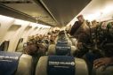 A first group of around 100 Kenyan soldiers from the East African Community regional force board a plane to leave the DRC