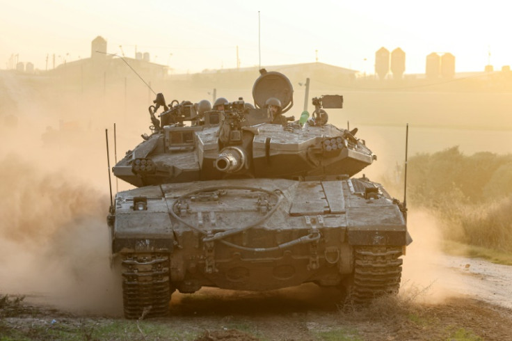 An Israeli military tank rolls near the border with the Gaza Strip
