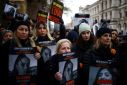 Demonstrators hold posters reading 'UN Women, your silence is loud' alongside pictures of Israeli women being held hostage in Gaza, during a rally in London on December 3, 2023