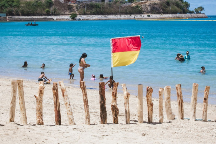 Red-and-yellow flags marked the perimeter protected from sharks