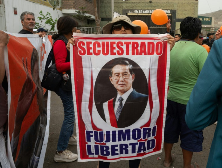 Supporters of former Peruvian president Alberto Fujimori gather at the entrance of Barbadillo prison to demand his release in the eastern outskirts of Lima on December 5, 2023