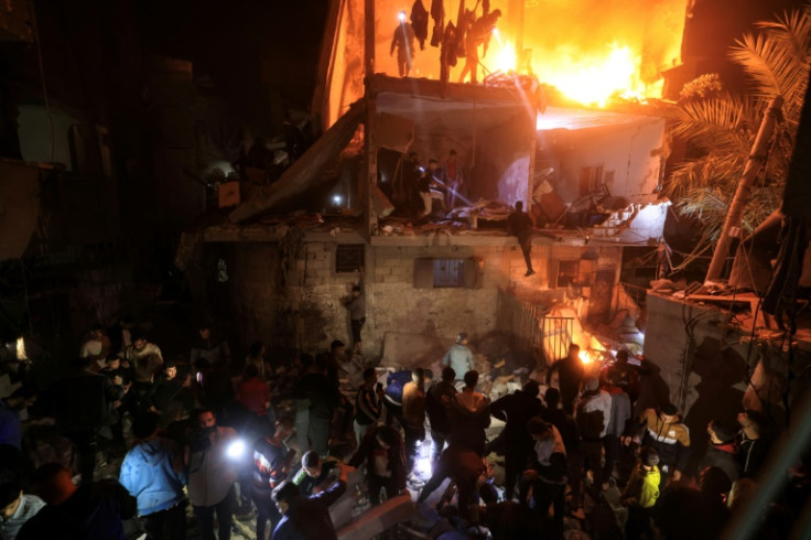 People search for victims in the rubble of a building after a strike on Rafah in southern Gaza