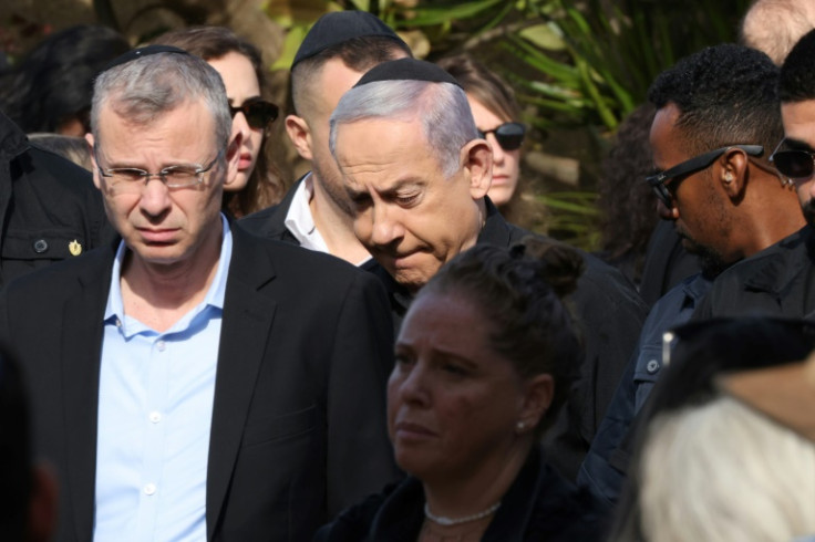 Israeli Prime Minister Benjamin Netanyahu (C) attends the funeral of Gal Eizenkot, the son of Israeli government war cabinet minister Gadi Eisenkot, killed in battles with Hamas militants in the Gaza Strip