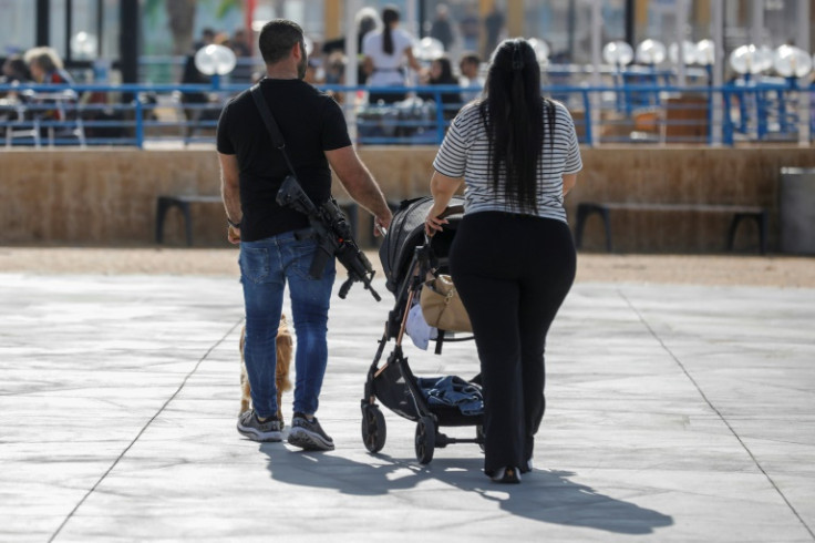 There are plenty of rifles slung over people's shoulders in Nahariya