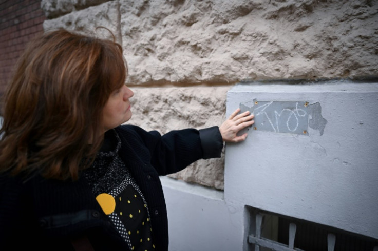 The words 'traitor' or 'spy' are sometimes scrawled where the plaques were