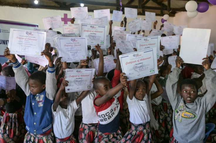 As the children received "certificates of achievement", their beaming relatives applauded and ululated