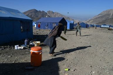 Afghan refugees play cricket at a makeshift camp upon their arrival from Pakistan, near the Afghanistan-Pakistan border