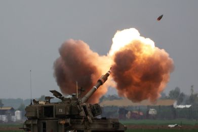An Israeli tank shells the Gaza Strip from southern Israel