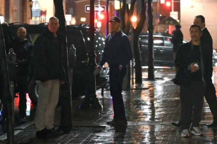 US President Joe Biden (C) looks on after a car hit a vechicle in the presidential motorcade as he left his campaign headquarters in Wilmington, Delaware