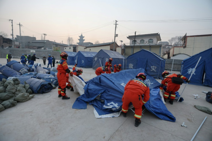 Rescue workers set up tents for people evacuated after the earthquake in Dahejia, Jishishan County