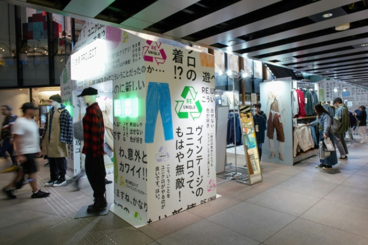 Customers browse through items sold as part of the Uniqlo Pre-owned Clothes Project at the brand's Harajuku store in Tokyo