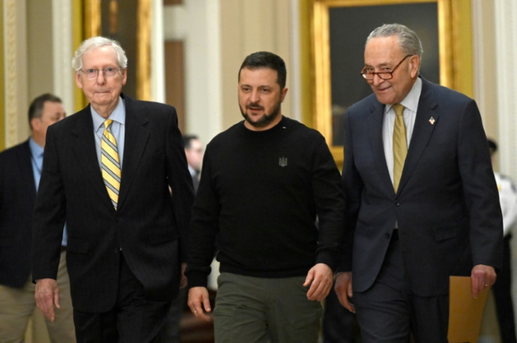 Ukrainian leader Volodymyr Zelensky (C) walks with Senate Minority Leader Mitch McConnell (L) and Majority Leader Chuck Schumer (R) at the US Capitol on December 12, 2023