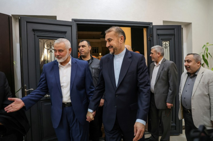 Qatar-based Hamas leader Ismail Haniyeh (L) welcomes Iranian Foreign Minister Hossein Amir Abdollahian (C), in Doha
