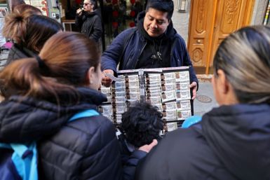 Spanish citizens and tourists spend hours in a queue to buy a ticket in  Spain's popular Christmas lottery "El Gordo" (the Fat One)