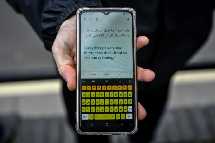 'They don't treat us like human beings,' reads a translated message on a migrant's phone