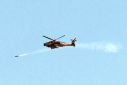An Israeli air force attack helicopter fires a missile while flying over the northern Gaza Strip near the border with southern Israel