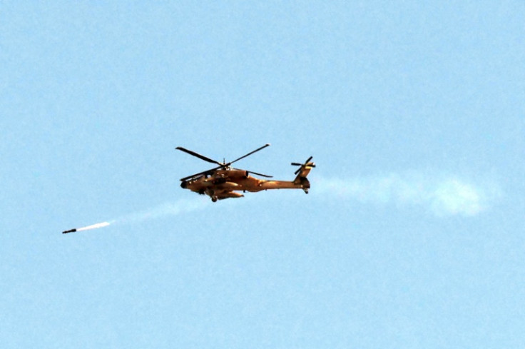 An Israeli air force attack helicopter fires a missile while flying over the northern Gaza Strip near the border with southern Israel