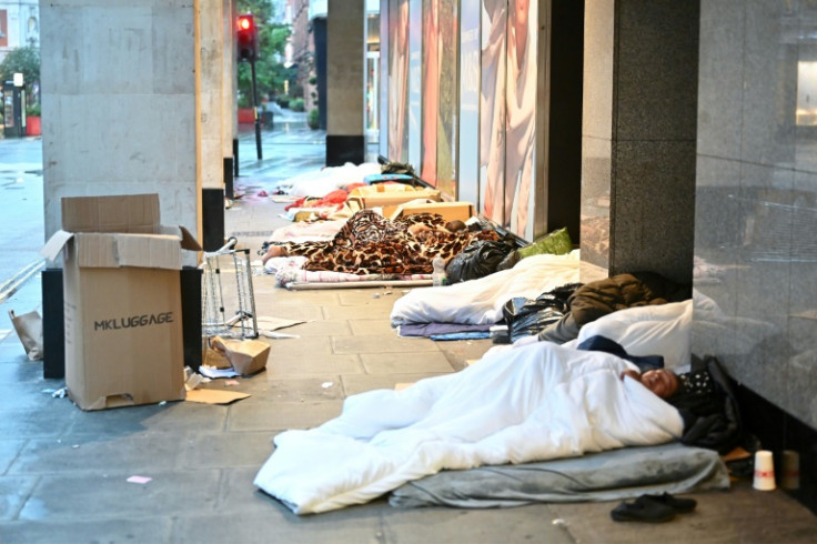 Rough sleepers lay in their makeshift beds outside closed shops, at daybreak on Oxford Street in London on August 2, 2023. Homeless has soared across Britain where a cost of living crisis has left many struggling to make ends meet. The CPRE charity said o