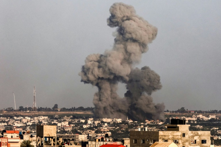 A plume of smoke rises over the southern Gaza strip following an Israeli bombardment on Tuesday