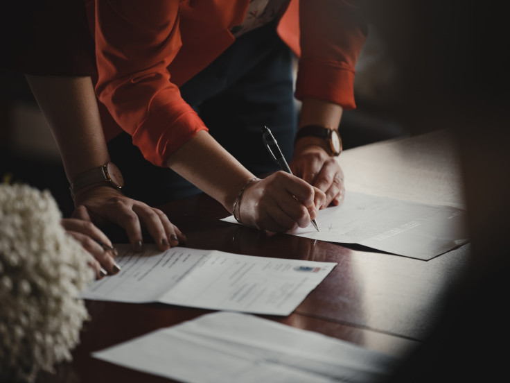 People signing documents for a wedding