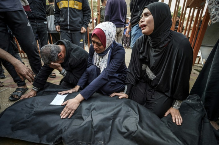Relatives mourn over the body of a loved one killed during Israeli bombardment at Nasser Hospital in Khan Yunis
