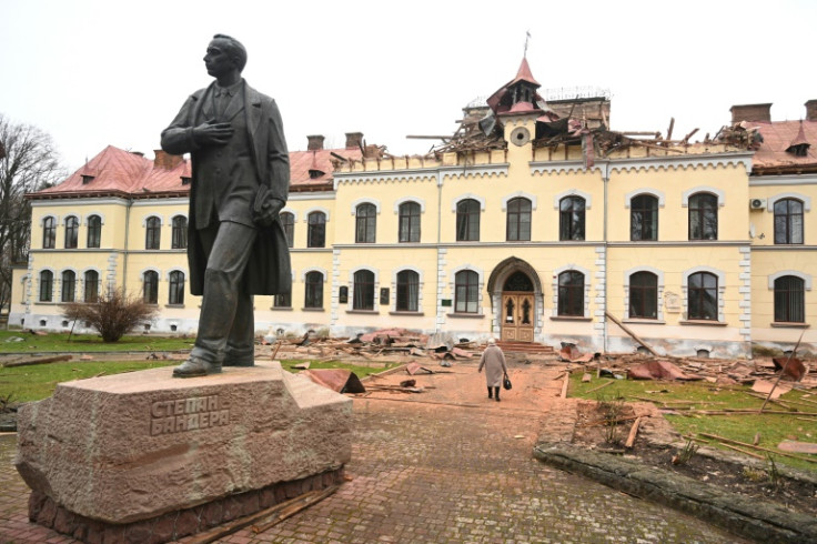 A woman walks past the damaged Lviv National University of Nature Management